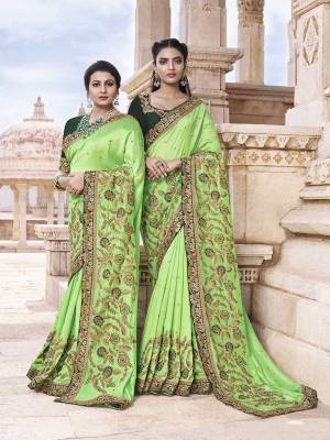Pretty Elegant Looking Heavy Designer Saree Is Here In Light Green Color Paired With Dark Green Colored Blouse. This Saree Is Fabricated On Soft Silk Paired With Art Silk Fabricated Blouse. It Is Beautified With Heavy Embroidery. Buy This Saree Now.