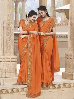 Celebrate This Festive Season With Beauty And Comfort Wearing This Attractive Looking Designer Saree In Saffron Color Paired With Saffron Colored Blouse. This Saree Is Fabricated On Satin Georgette Paired With Art Silk Fabricated Blouse. It Is Beautified With Minimal Subtle Embroidery. 