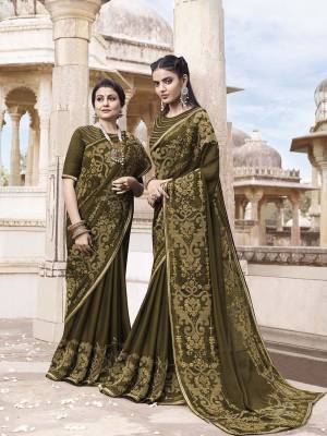 New Shade Is Here To Add Into Your Wardrobe With This Heavy Designer Saree In Dark Olive Green Color. This Pretty Saree Is Georgette Based Paired With Art Silk Fabricated Blouse. It Has Very Attractive Embroidery Which Will Earn You Lots Of Compliments From Onlookers. 