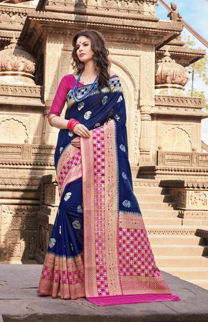 Enhance Your Personality Wearing This Designer Saree In Navy Blue Color Paired With Contrasting Magenta Pink Colored Blouse. This Saree And Blouse are Fabricated On Nylon Art Silk Beautified With Weave All Over. 