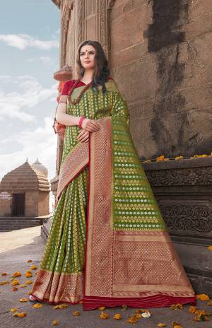 For A Proper Traditional Look, Grab This Silk Based Saree In Green Color Paired With Contrasting Maroon Colored Blouse. This Saree And Blouse Are Fabricated On Nylon Art Silk Beautified With Small Motif Weave All Over. 