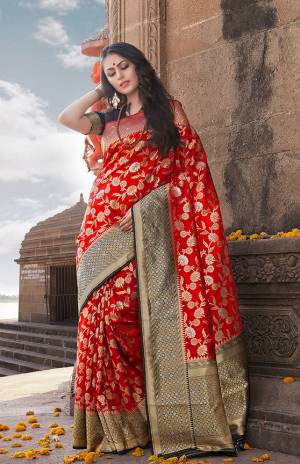 Grab This Beautiful Designer Silk Based Saree In Red Color Paired With Black Colored Blouse, This Saree And Blouse Are Fabricated On Nylon Art Silk Beautified With Weave All Over It, Its Fabric Is Durable And Easy To Care For. 