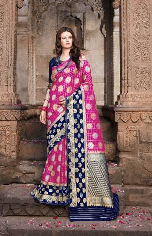 Enhance Your Personality Wearing This Designer Saree In Magenta Pink Color Paired With Contrasting Navy Blue Colored Blouse. This Saree And Blouse are Fabricated On Nylon Art Silk Beautified With Weave All Over. 