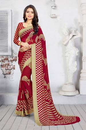Grab This Pretty Printed Saree In Maroon Color Paired With Maroon Colored Blouse. This Saree And Blouse are Fabricated On Georgette Beautified With Prints. 