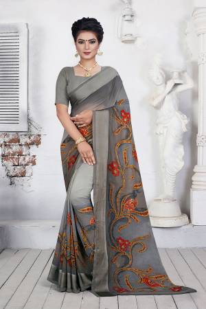Flaunt Your Rich And Elegant Taste Wearing This Simple Saree In Grey Color Paired With Grey Colored Blouse. This Saree And Blouse are Fabricated On Georgette Which IS Soft Towards Skin And Easy To Carry All Day Long. 