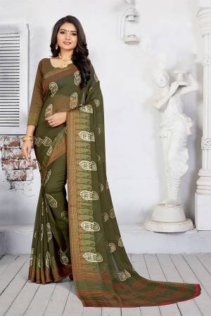 Add This New Shade To Your Wardrobe With This Printed Saree In Olive Green Color Paired With Olive Green Colored Blouse. This Saree And Blouse Are Fabricated On Georgette Beautified With Printed Motifs.