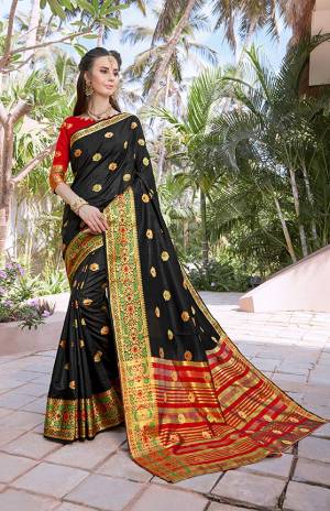 Celebrate This Festive Season With Beauty And Comfort Wearing This Silk Based Saree In Black Color Paired With Contrasting Red Colored Blouse. This Saree And Blouse Are Fabricated On Banarasi Art Silk Beautified With Weave All Over. Buy This Saree Now.