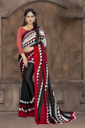 Add Some Casuals To Your Wardrobe With This Printed Saree In Black And Red Color Paired With Red Colored Blouse. This Saree And Blouse Are Fabricated On Crepe Jacquard Beautified With Prints. 