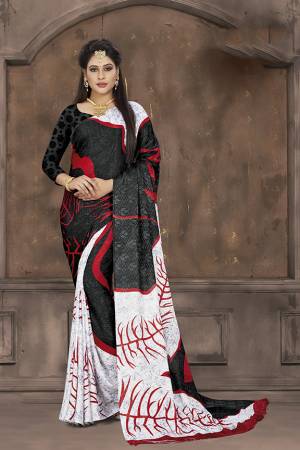 Add Some Casuals To Your Wardrobe With This Printed Saree In Black And White Color Paired With Black Colored Blouse. This Saree And Blouse Are Fabricated On Crepe Jacquard Beautified With Prints. 