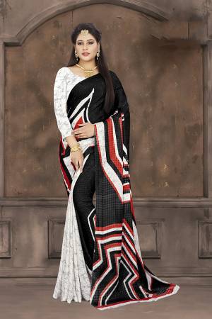 Simple Saree For Your Casual Wear Is Here In Black And White Color Paired With White Colored Blouse. This Saree And Blouse are Fabricated On Crepe Jacquard Beautified With Prints. Grab this Light Weight Saree For Casuals Now.