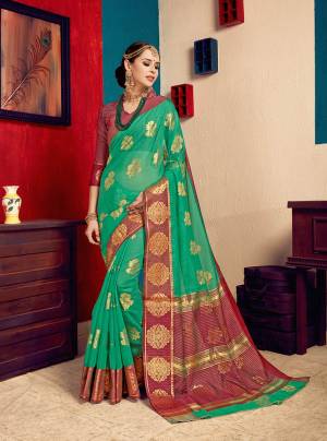 This Festive Season, Look The Most Pretty And Attractive of All Wearing This Saree In Green Color Paired With Contrasting Maroon  Colored Blouse. This Saree Is Fabricated On Cotton Silk Paired With Art Silk Fabricated Blouse. Buy Now.