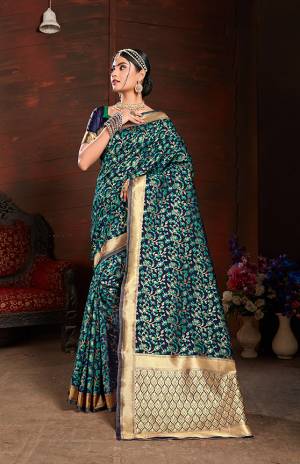 Add This Very Pretty Silk Based Saree To Your Wardrobe In Sea Green With A Base OF Navy Blue Color. This Saree Is Fabricated On Banarasi Art Silk Paired With Art Silk Fabricated Blouse. It Is Beautified With Small Floral Weave All Over It. 