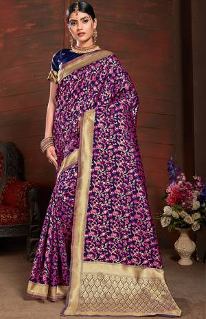 Add This Very Pretty Silk Based Saree To Your Wardrobe In Magenta Pink With A Base OF Navy Blue Color. This Saree Is Fabricated On Banarasi Art Silk Paired With Art Silk Fabricated Blouse. It Is Beautified With Small Floral Weave All Over It. 
