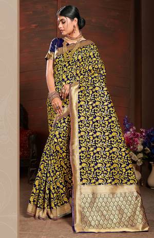 Add This Very Pretty Silk Based Saree To Your Wardrobe In Yellow With A Base OF Navy Blue Color. This Saree Is Fabricated On Banarasi Art Silk Paired With Art Silk Fabricated Blouse. It Is Beautified With Small Floral Weave All Over It. 