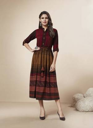 For A Rich And Elegant Look, Grab This Pretty Simple Readymade Kurti In Maroon And Brown Color Fabricated On Rayon. This Kurti Is Beautified With Lining Prints. Also It Is Available In All Sizes, Choose As Per Your Comfort. 