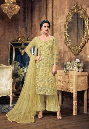 Grab This Heavy Embroidered Designer Straight Suit In Very Pretty And Unique Shade In Light Green Color. Its Top And Dupatta Are Fabricated On Net Paired With Satin Silk Fabricated Bottom. It Is Beautified With Embroidered Over And Bottom both. 