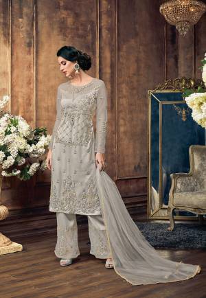 For A Rich And Elegant Look, Grab This Designer Straight Suit In Grey Color. Its Heavy Embroidered Top IS Fabricated On Net Paired With Satin Silk Embroidered Bottom And Net Fabricated Dupatta. It Color And Embroidery Gives A Heavy As Well As Subtle Look To Your Personality. 