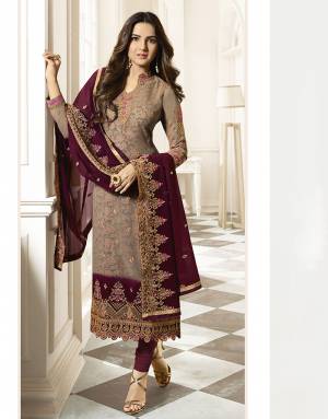 Rich And Elegant Looking Heavy Embroidred Designer Straight Suit Is Here With A Pretty Digital Printed Inner Pattern. Its Top Is In Beige Color Paired With Magenta Pink Colored Bottom And Dupatta. This Pretty Suit Is Georgette Based Paired With Santoon Fabricated Bottom. 