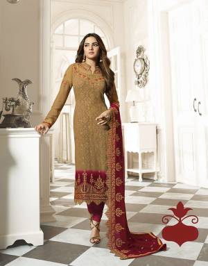 Rich And Elegant Looking Heavy Embroidred Designer Straight Suit Is Here With A Pretty Digital Printed Inner Pattern. Its Top Is In Light Brown Color Paired With Red Colored Bottom And Dupatta. This Pretty Suit Is Georgette Based Paired With Santoon Fabricated Bottom. 
