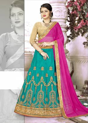 Add This Pretty Designer Lehenga Choli To Your Wardrobe In Golden Colored Blouse Paired With Blue Colored Lehenga And Contrasting Rani Pink Colored Dupatta. Its Blouse Is Fabricated on Art Silk Paired With Satin Silk Lehenga And Chiffon Dupatta. All Its Fabrics Are Light Weight And Easy To Carry Throughout The Gala.