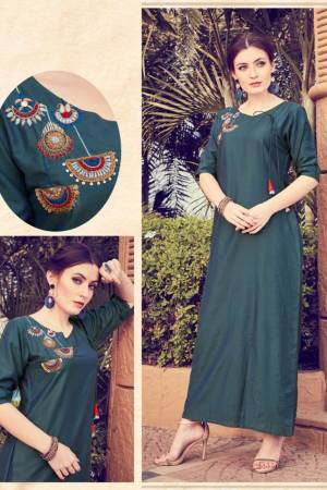 Add This Pretty Readymade Kurti To your Wardrobe In Dark Teal Blue Color. It Is Beautified With Unique Pattern And Attractive Embroidery Which Will Earn You Lots Of Compliments From Onlookers. 