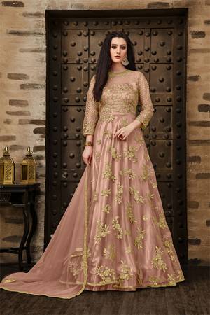 Add This Very Pretty Rich And Elegant Looking Designer Floor Length Suit In Dusty Pink Color. This Heavy Embroidered Suit IS Net Based Paired With Santoon Bottom And Net Dupatta. Its Rich Color And Elegant Embroidery Will earn You Lots Of Compliments From onlookers. Buy Now.