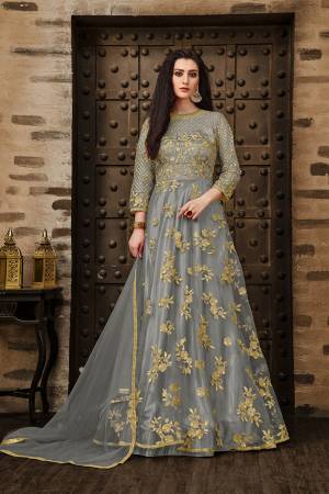 Add This Very Pretty Rich And Elegant Looking Designer Floor Length Suit In Grey Color. This Heavy Embroidered Suit IS Net Based Paired With Santoon Bottom And Net Dupatta. Its Rich Color And Elegant Embroidery Will earn You Lots Of Compliments From onlookers. Buy Now.