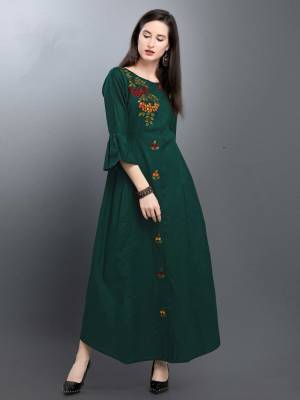 For Your Semi-Casual Wear, Grab This Readymade Long Kurti In Dark Green Color. This Kurti Is Silk Based Beautified With Thread Work. 