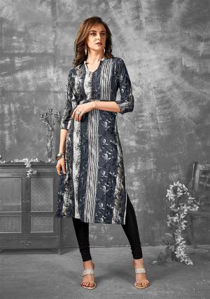 Add This Very Pretty Designer Readymade Kurti To Your Wardrobe In Dark Grey Color Fabricated On Rayon. This Pretty Kurti Is Beautified With Abstract Floral & Lining Prints All Over. 