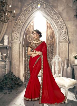 Adorn The Pretty Angelic Look Wearing This Designer Saree In Red Color Paired With Brown Colored Blouse. This Plain Saree Is Chiffon Based Paired With Art Silk Fabricated Blouse. It Is Beautified With Heavy Embroidery Over The Blouse And Saree Lace Border. 