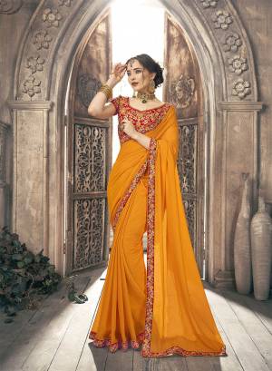 Adorn The Pretty Angelic Look Wearing This Designer Saree In Musturd Yellow Color Paired With Red Colored Blouse. This Plain Saree Is Chiffon Based Paired With Art Silk Fabricated Blouse. It Is Beautified With Heavy Embroidery Over The Blouse And Saree Lace Border. 