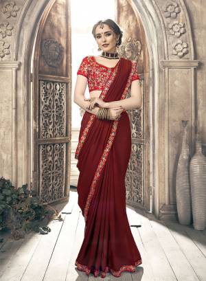 Grab This Very Beautiful And Attractive Looking Designer Saree In Heavy Blouse concept. This Chiffon Based Saree Is In Maroon Color Paired With Red Colored Art Silk Fabricated Blouse. Buy This Saree Now.