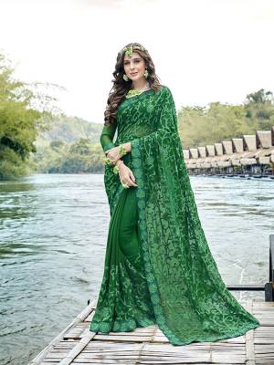 Bright And Visually Appealing Color Is Here With This Heavy Designer Saree In Dark Green Color Paired With Dark Green Colored Blouse. This Saree And Blouse Are Georgette Based Which Is Soft Towrds Skin And Easy To Carry All Day Long. 