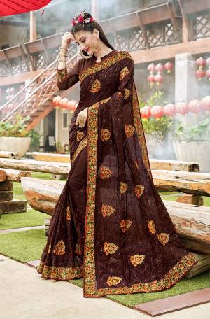 Enhance Your Personality Wearing This Very Beautiful Heavy Designer Saree In Brown Color Paired With Brown Colored Blouse. This Saree And Blouse Are Georgette Based Beautified With Heavy Embroidery. 