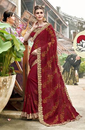 Get Ready For The Upcoming Festive And Wedding Season With This Heavy Designer Saree In Maroon Color Paired With Maroon Colored Blouse. It Is Beautified With Heavy Embroidery All Over Which Will earn You Lots of Compliments From Onlookers. 