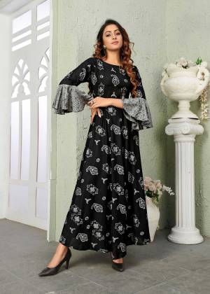 For A Bold And Beautiful Look, Grab This Designer Readymade Gown In Black Color Fabricated On Muslin. This pretty Gown Is Beautified With Prints All Over With Bell Sleeve Pattern.