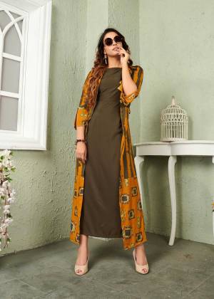 Add This Beautiful And Trendy Designer Piece To Your Wardrobe In Olive Green And Musturd Yellow Color. It Is Fabricated On Muslin Beautified With Prints And Thread Work. 