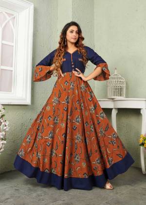 New And Unique Color Pallete Is Here Is Here With This Designer Readymade Gown In Rust And Navy Blue Color Fabricated On Muslin. It Is Beautified With Prints Which Is Light Weight, Durable And Easy to Carry All Day Long. 