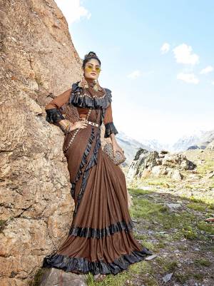 Enhance Your Personality Wearing This Very Beautiful Designer Saree In Brown Color Paired With Brown Colored Blouse. This Saree Is Fabricated On Lycra Paired With Art Silk Fabricated Blouse. Its Rich Color Will Earn You Lots Of Compliments From Onlookers. 