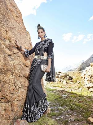 For A Bold And Beautiful Look, Grab This Designer Lycra Based Saree In Dark Grey Color Paired With Black Colored Blouse. This Saree Is Beautified With Frill And Fancy Lace Border. It Is Light Weight And Durable. Buy Now.
