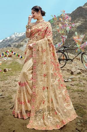 Flaunt Your Rich And Elegant Taste In This Very Beautiful Designer Saree In Beige Color Paired With Beige Colored Blouse. This Saree And Blouse Are Fabricated On Net Beautified With Heavy Embroidery In Tone To Tone And Also Contrasting Threads. 