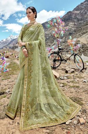 This Season Is About Subtle Shades And Pastel Play, So Grab This Very Pretty Heavy Designer Saree In Pastel Green Color Paired With Pastel Green Colored Blouse. This Saree And Blouse Are Fabricated On Net Beautified With Attractive And Unique Patterned Embroidery. Buy This Pretty Saree Now.