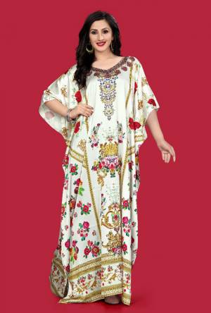A Must Have Piece To Your Wardrobe Is Here With This Beautiful Readymade Kaftan In White Color. This Pretty Kaftan Is Fabricated on Satin beautified With Prints And Stone Work. Also It Is In Free Size Which Ensures Superb Comfort. Buy Now.