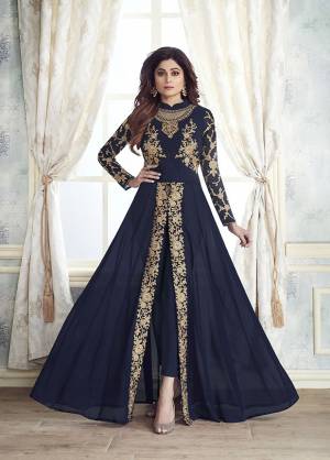 Enhance Your Personality Wearing This Designer Indo-Western Dress In Navy Blue Color With Fornt Slit Pattern And Straight Pants. Its Heavy Embroidered Top Is Fabricated On Georgette Paired With Santoon Bottom And Chiffon Fabricated Dupatta. All Its Fabrics Are Light Weight , Durable And Esnures Superb Comfort Throughout The Gala. Buy Now.