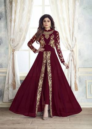 Enhance Your Personality Wearing This Designer Indo-Western Dress In Maroon Color With Fornt Slit Pattern And Straight Pants. Its Heavy Embroidered Top Is Fabricated On Georgette Paired With Santoon Bottom And Chiffon Fabricated Dupatta. All Its Fabrics Are Light Weight , Durable And Esnures Superb Comfort Throughout The Gala. Buy Now.