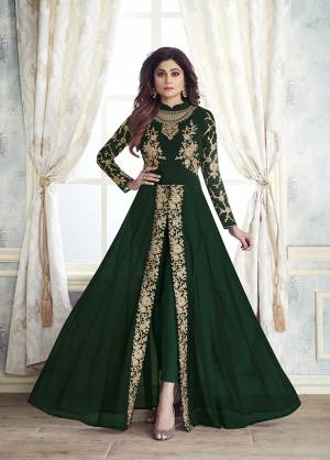 Enhance Your Personality Wearing This Designer Indo-Western Dress In Dark Green Color With Fornt Slit Pattern And Straight Pants. Its Heavy Embroidered Top Is Fabricated On Georgette Paired With Santoon Bottom And Chiffon Fabricated Dupatta. All Its Fabrics Are Light Weight , Durable And Esnures Superb Comfort Throughout The Gala. Buy Now.