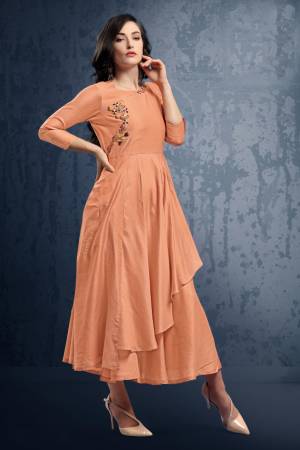 Grab This Pretty Peach Colored Readymade Kurti Which IS Silk Based. This Kurti Has Double Layered Pattern With Hand Work Over The Yoke. Buy This Kurti Now.
