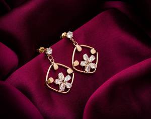 Here Is A Very Pretty Pair Of Simple And Elegant Looking Earring Set In Golden color. It Has Pretty Unique pattern With Attractive Diamond Work. You can Pair This Even With Simple Attire As Well As A Heavy One. This Pretty Evergreen Design Compliments Any Kind Of Attire You Wear. 