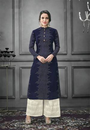 Enhance Your Personality Wearing This Designer Readymade Pair In Kurti And Plazzo. This Pretty Foil Printed Kurti Is In Navy Blue Color Fabricated On Art Silk Paired With Cotton Fabricated Thread Embroidered Bottom. Both The Top And Bottom are Fully Stitched And Available In All Sizes. 