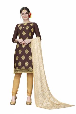 If Those Readymade Suit Does Not Lend You The Desired Comfort Than Grab This Dress Material And Get This Stitched As Per Your Desired Fit And Comfort. Its Top Is In Dark Brown Color Paired With Beige Colored Bottom And Dupatta. Buy This Pretty Elegant Cotton Based Dress Material Now.